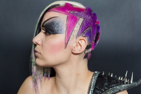 Woman with multicoloured hair and spike dressの写真素材