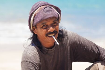 BALI - FEBRUARY 13. Portrait of line fisherman on Jimberan beach on February 13, 2012 in Bali, Indonesia. Local fishermen find it harder to make a living due to a lack of fish caused by industrial fishing.のeditorial素材