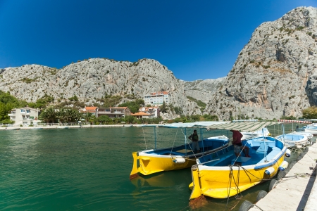 OMIS, CROATIA - AUGUST 28, 2012: Men in boats on the River Cetina on August 28, 2012 in Omis, Croatia. Cetina River empties into the sea in Omis.のeditorial素材