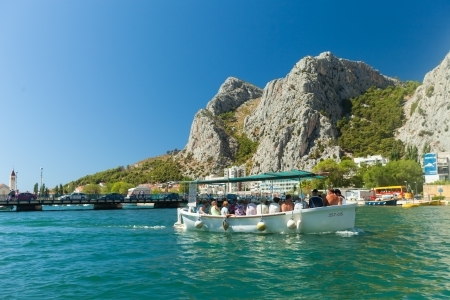 OMIS, CROATIA - AUGUST 28, 2012: People in boat  going on the tour on the River Cetina on August 28, 2012 in Omis, Croatia. Cetina River empties into the sea in Omis.のeditorial素材