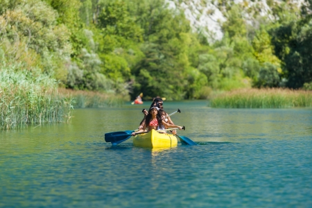 OMIS, CROATIA - AUGUST 28, 2012: Family in kayak  going on the tour on the River Cetina on August 28, 2012 in Omis, Croatia. Cetina River empties into the sea in Omis.のeditorial素材