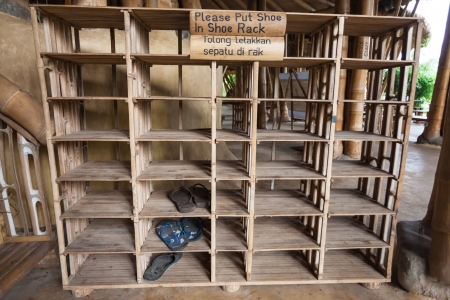 BALI, INDONESIA - FEBRUARY 2012: Shoe rack at the Green School on Februray 27, 2012 in Bali, Indonesia. The school is known for promoting eco-friendly concepts to its students.のeditorial素材
