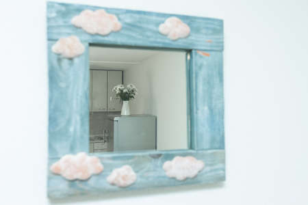 Mirror with blue wooden frame in home interior