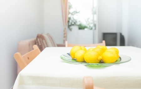 Modern and bright living room interior in house with lemons on tableの写真素材