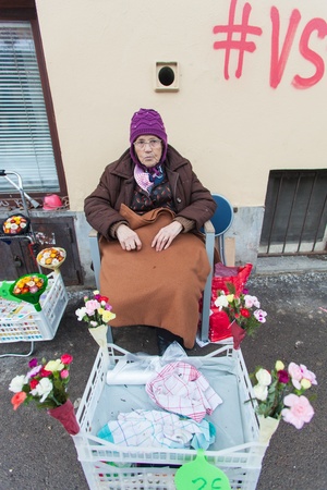 LJUBLJANA - FEB 17  Old lady selling fresh flowers on walkway on February 17, 2013 in Ljubljana, Slovenia  The crisis and low retirement income forces the elderly to find alternative income sources のeditorial素材