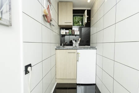 Small kitchen with white tiles on the wallのeditorial素材