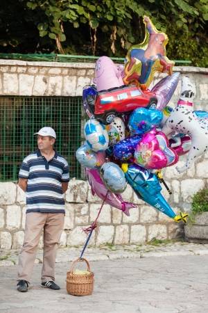 SARAJEVO, BOSNIA AND HERZEGOVINA - AUGUST 13, 2012: Man sells helium balloons on Bascarsija, the old town, very popular tourist place.のeditorial素材