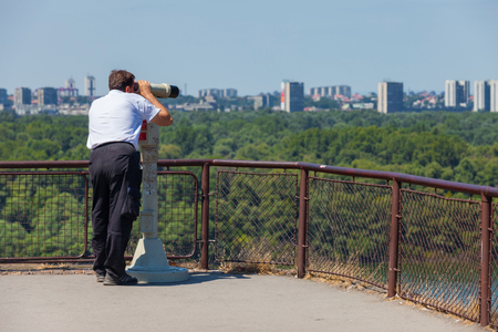 BELGRADE, SERBIA - AUG 15: Tourist using binoculars on August 15, 2012 in Belgrade, Serbia. City is very popular tourist destination in summer time.  のeditorial素材