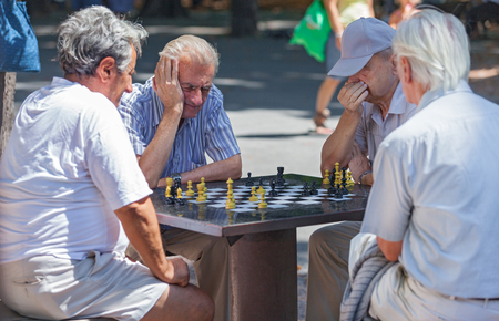 BELGRADE, SERBIA - AUG 15: Old men playing chess on  the street on August 15, 2012 in Belgrade, Serbia. City has plan to put chessboards on public surfaces.のeditorial素材
