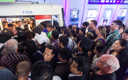 BANGKOK, THAILAND - JANUARY 10, 2012: People at crowded BTS Skytrain station entering the train....