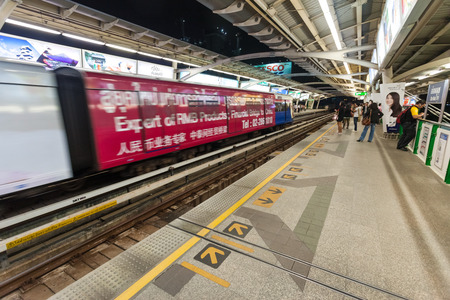 BANGKOK, THAILAND - JANUARY 10, 2012: People at  BTS Skytrain station entering the train. 600,000...