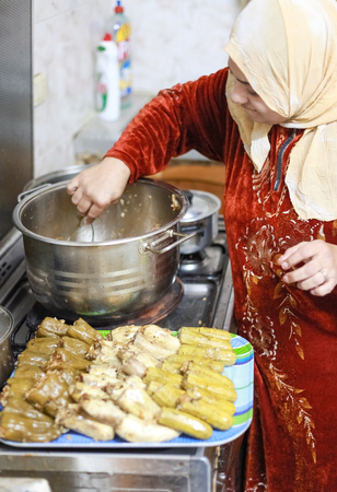 DAHAB, EGYPT - FEBRUARY 2, 2011: Egyptian woman prepares traditional meal. Egyptian food is a mixture of all the different civilisations that came to Egypt in the history of its existence.のeditorial素材