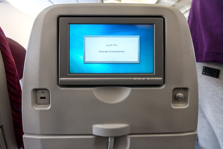 Economy class seat with entertainment system onboard.の写真素材