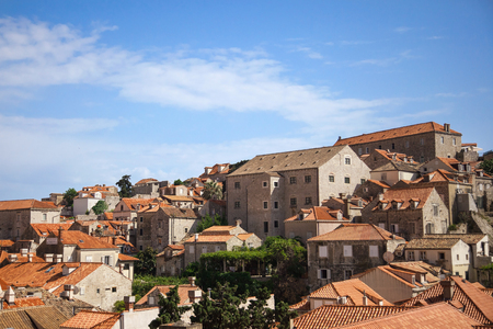 DUBROVNIK, CROATIA - MAY 26, 2014: Old houses inside the city walls with Lokrum island in background. City wall is one of most popular tourist attraction in Dubrovnik.のeditorial素材
