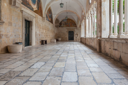 DUBROVNIK, CROATIA - MAY 26, 2014: Hallway around famous courtyard in the Monastery of the Friars minor. It is the most important work from the transitional period from the Romanesque to Gothic styleのeditorial素材