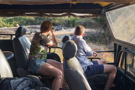 YALA NATIONAL PARK, SRI LANKA - MARCH 4, 2014: Tourists taking photos from jeep during safari tour in the Yala park. Yala is the second largest national park in Sri Lanka.のeditorial素材