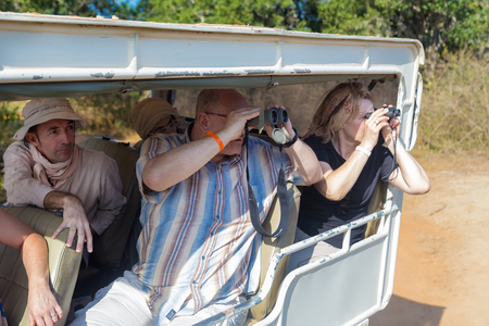 YALA NATIONAL PARK, SRI LANKA - MARCH 4, 2014: Tourists looking through binoculars during safari tour in the Yala park. Yala is the second largest national park in Sri Lanka.のeditorial素材