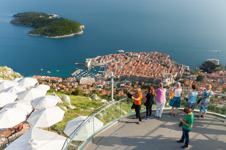 DUBROVNIK, CROATIA - MAY 26, 2014: Tourists at viewpoint near Dubrovnik cable car station which connects Ploce and  mountain Srdj above town where you can enjoy a panoramic view of Old Town and the surrounding islands.のeditorial素材