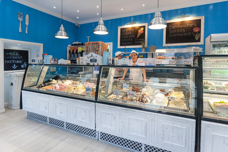 DUBROVNIK, CROATIA - MAY 26, 2014: Smiling young waitress at Gossip ice cream shop on main street Stradun. It is one of the best ice cream place in town popular among tourists.のeditorial素材