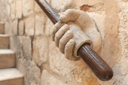 Closeup of the stone hand holding stairway railing in the Rector's Palace in Dubrovnik, Croatia.の写真素材