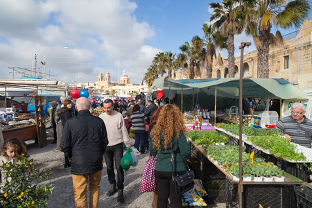 MARSAXLOKK, MALTA - JANUARY 11, 2015: People at Marsaxlokk market, one of the city's main features especially on sunday.のeditorial素材