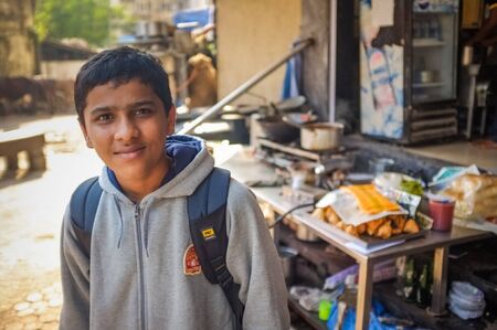 MUMBAI, INDIA - 09 JANUARY 2015: Indian school boy in front of shop.