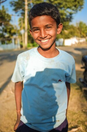 HAMPI, INDIA - 01 FEBRUARY 2015: Indian boy on street with photographers shadow on shirtのeditorial素材