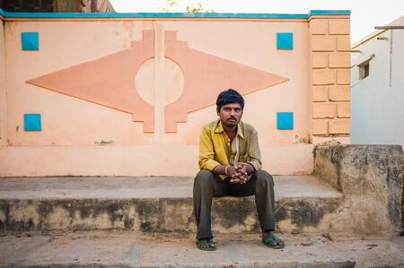 KAMALAPURAM, INDIA - 02 FABRUARY 2015: Single indian man sitting in street ina atown close to Hampi