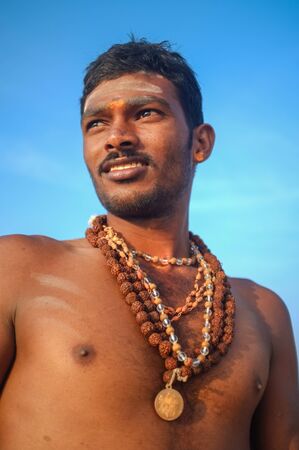 KAMALAPURAM, INDIA - 03 FEBRUARY: Indian pilgrim with religious necklaces and painted face on hilltopのeditorial素材