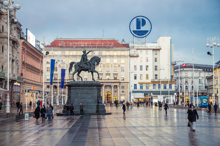 ZAGREB, CROATIA - 11 MARCH 2015: Zagreb's main square with Ban Josip Jelacic statue and surrounding buildings on a wet evening.のeditorial素材
