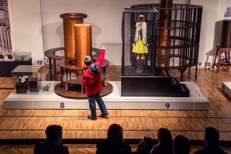 ZAGREB, CROATIA - 17 MARCH 2015: Museum staff showing an exibition to visitors in the Tesla part of the museum in Tehnicki muzej in Zagreb.のeditorial素材