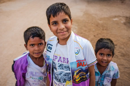 KAMALAPURAM, INDIA - 02 FABRUARY 2015: Three Indian boys standing in streetのeditorial素材