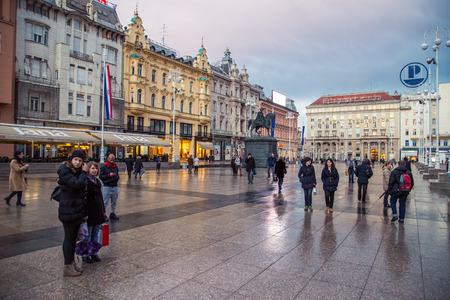ZAGREB, CROATIA - 11 MARCH 2015: Zagreb's main square with Ban Josip Jelacic statue and surrounding buildings on a wet evening.のeditorial素材