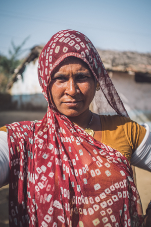GODWAR REGION, INDIA - 13 FEBRUARY 2015: Rabari tribeswoman in sari decorated with traditional upper-arm bracelets. Post-processed with grain, texture and colour effect.のeditorial素材