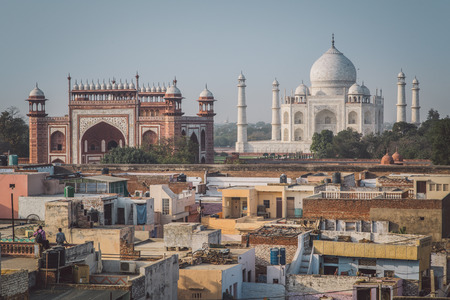 AGRA, INDIA - 27 FEBRUARY 2015: Taj Mahal, Great Gate and rooftops of neighbouring houses. Post-processed with grain, texture and colour effect.のeditorial素材