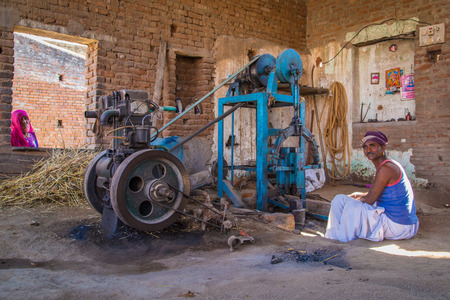 GODWAR REGION, INDIA - 14 FEBRUARY 2015: Mechanic with moustache wearing headscarf and big golden...