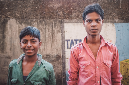 MUMBAI, INDIA - 12 JANUARY 2015: Young Indian men in Dharavi slum. Post-processed with grain, texture and colour effect.のeditorial素材