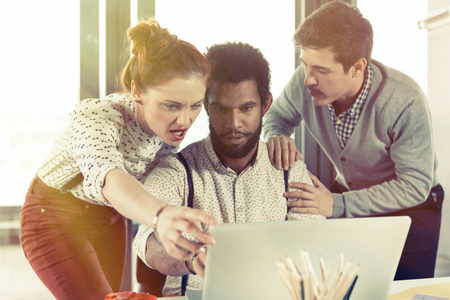 Business people in modern office working on project. Post processed with vintage filter.の写真素材