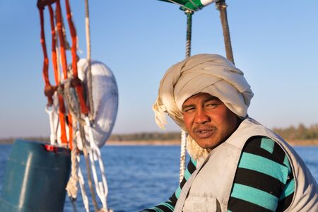 EGYPT -  FEBRUARY 9, 2016: Portrait of Nubian felucca sailing crew man on trip on the Nile.の写真素材