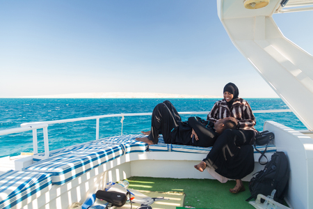 PARADISE ISLAND, EGYPT - FEBRUARY 12: Tourists couple on dive boat going snorkeling on Paradise Island.のeditorial素材