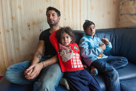 ZAGREB, CROATIA - OCTOBER 21, 2013: Roma man and his children at their home.のeditorial素材
