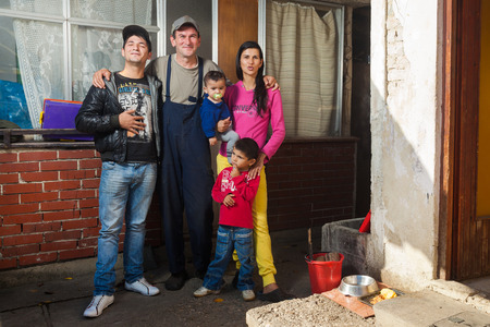 ZAGREB, CROATIA - OCTOBER 21, 2013: Roma family posing in front of their house.のeditorial素材