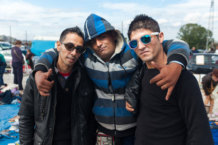 ZAGREB, CROATIA - OCTOBER 20, 2013: Roma salesmen posing for camera at Zagreb's flea market Hrelic.