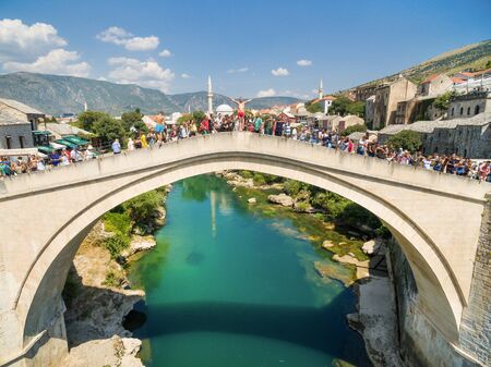 People at Old Bridge over Neretva river in Mostar, Bosnia and Herzegovina.のeditorial素材