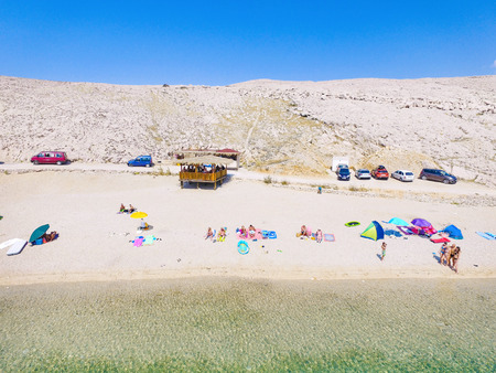 PAG, CROATIA - OCTOBER 1, 2016: Aerial view of people enjoying at Drazica beach at island of Pag.のeditorial素材
