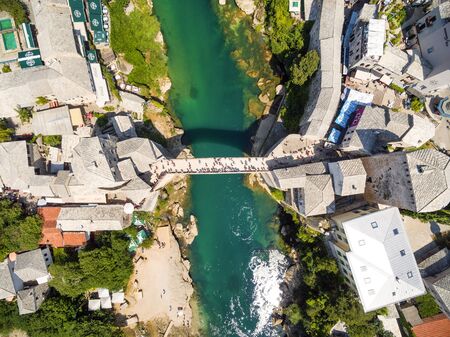 Aerial view of people crossing Old Bridge over Neretva river in Mostar, Bosnia and Herzegovina.のeditorial素材