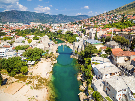 Aerial view of people crossing Old Bridge over Neretva river in Mostar, Bosnia and Herzegovina.のeditorial素材