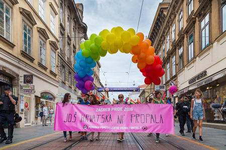 ZAGREB, CROATIA - JUNE 11, 2016: 15th Zagreb pride. LGBTIQ activists holding pride banner.のeditorial素材