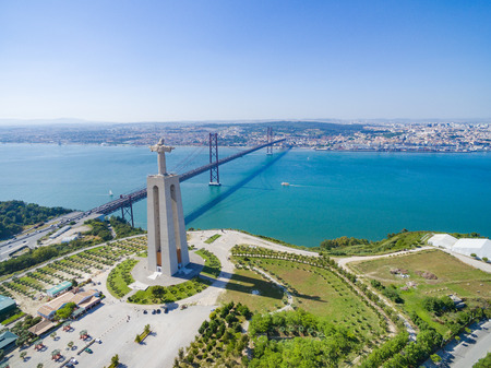 ALMADA, PORTUGAL - MAY 22, 2017: Aerial view of Sanctuary of Christ the King overlooking Lisbon and 25 de Abril Bridge connecting Lisbon and Almada.のeditorial素材