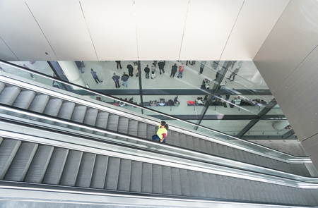 ZAGREB AIRPORT - 24 APRIL 2017: Aerial view of passengers waiting in hall, escalators passing.のeditorial素材